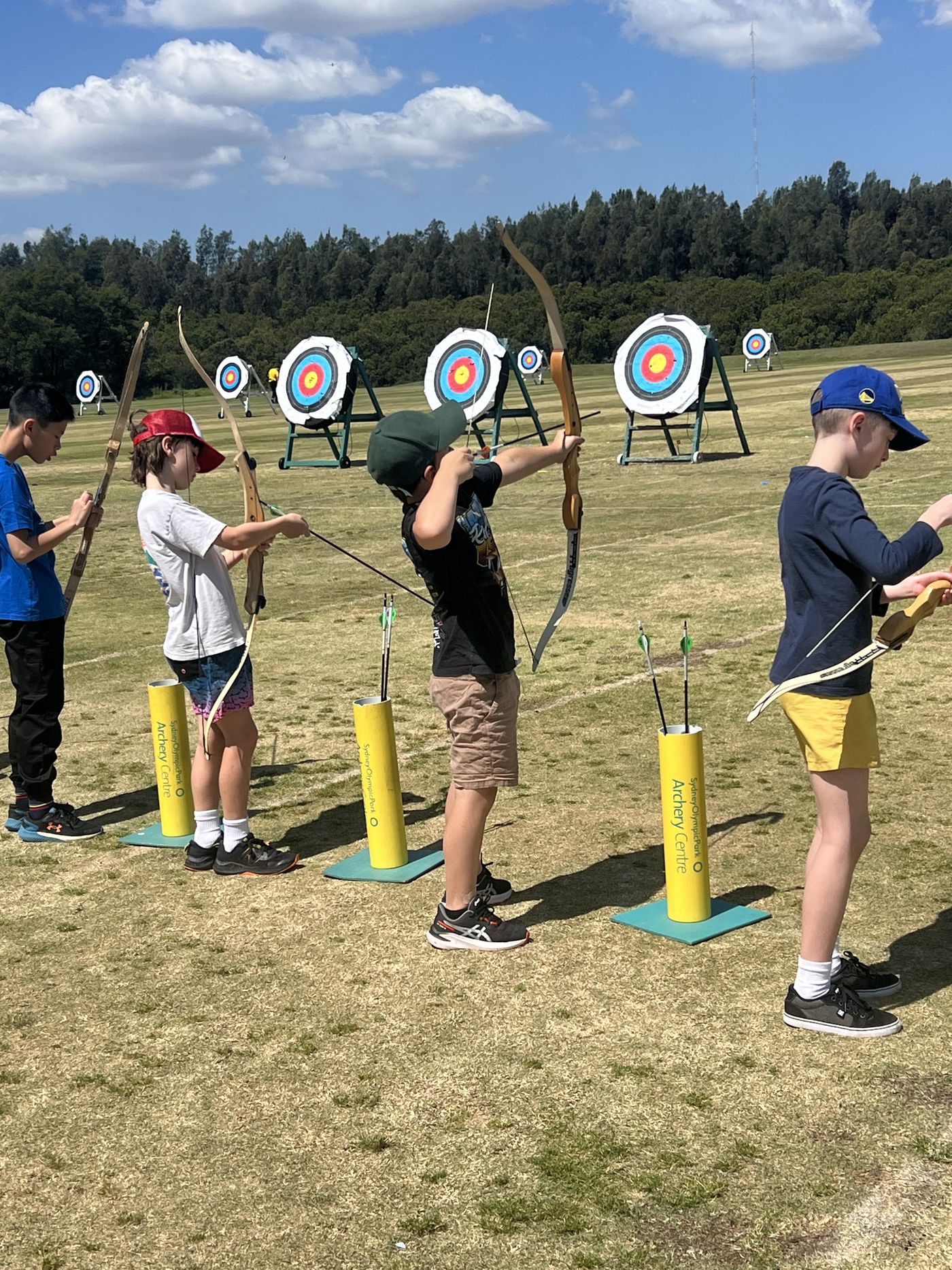 A young person taking aim at an archery range